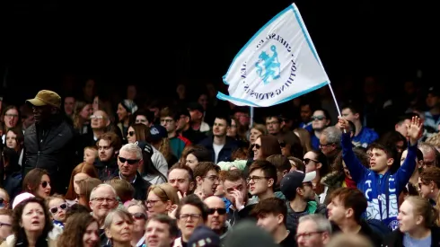 Chelsea fans wave flags in support of their team during the UEFA Women's Champions League semifinal 1st leg match between Chelsea FC and FC Barcelona at Stamford Bridge on April 22, 2023 in London, England.