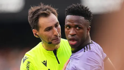 Referee Ricardo de Burgos Bengoetxea speaks with Vinicius Junior of Real Madrid during the LaLiga Santander match between Valencia CF and Real Madrid CF at Estadio Mestalla on May 21, 2023 in Valencia, Spain.