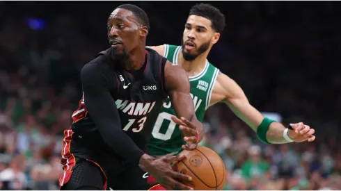 Bam Adebayo #13 of the Miami Heat controls the ball ahead of Jayson Tatum #0 of the Boston Celtics