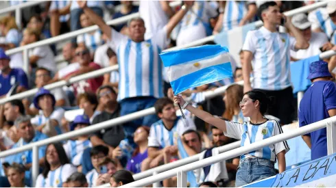 A fan of Argentina waves a flag
