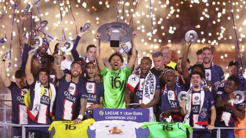 Marquinhos of Paris Saint-Germain, wearing a match shirt featuring the name of Sergio Rico and number 16, lifts the Ligue 1 Uber Eats trophy after the Ligue 1 match between Paris Saint-Germain and Clermont Foot at Parc des Princes on June 03, 2023 in Paris, France.