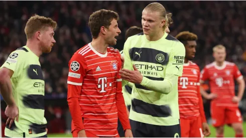 Erling Haaland of Manchester City reacts towards Thomas Mueller of FC Bayern Munich