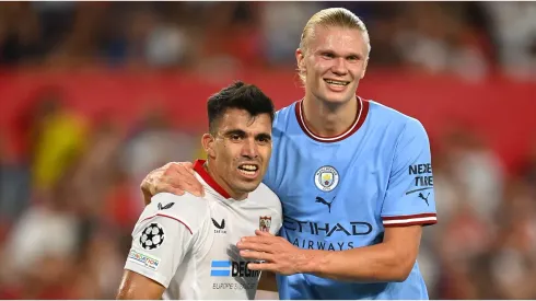 Marcos Acuna of Sevilla FC reacts with Erling Haaland of Manchester City