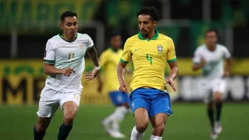 Marquinhos of Brazil fights for the ball with Bruno Miranda of Bolivia