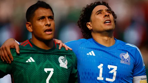 Luis Romo #7 and Guillermo Ochoa #13 of Mexico