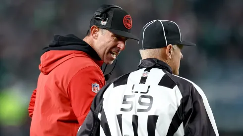 49ers head coach Kyle Shanahan speaks with line judge Rusty Baynes #59 during the third quarter in the game against the Philadelphia Eagles at Lincoln Financial Field on December 03, 2023 in Philadelphia, Pennsylvania.