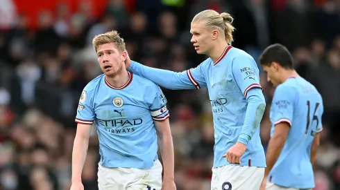 Kevin De Bruyne of Manchester City looks dejected while being consoled by teammate Erling Haaland after Bruno Fernandes of Manchester United scores the team's first goal during the Premier League match between Manchester United and Manchester City at Old Trafford on January 14, 2023 in Manchester, England.