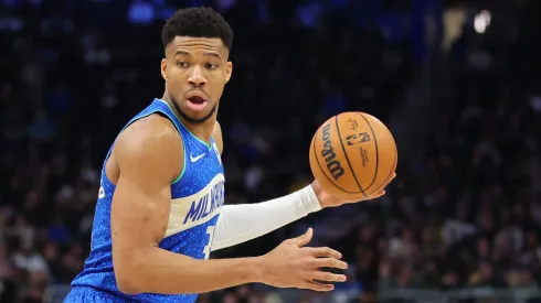 Giannis Antetokounmpo dribbling the basketball.