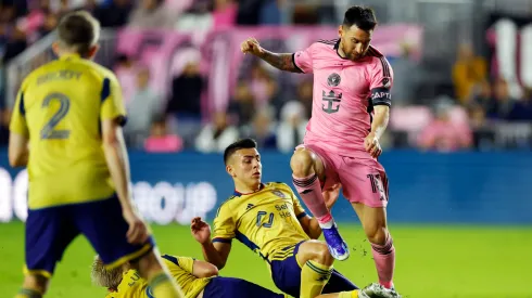 Lionel Messi #10 of Inter Miami dribbles against Diego Luna #8 and Braian Ojeda #6 of Real Salt Lake during the first half at Chase Stadium on February 21, 2024 in Fort Lauderdale, Florida.