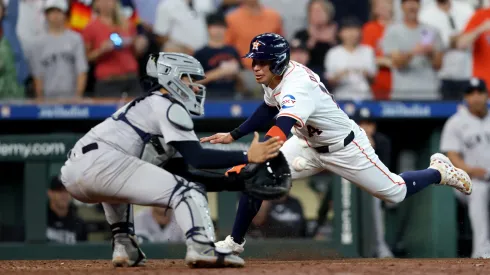 Mauricio Dubon #14 of the Houston Astros is out at the plate in the ninth inning against Jose Trevino #39 of the New York Yankees on Opening Day at Minute Maid Park on March 28, 2024 in Houston, Texas.