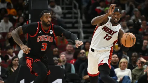 Bam Adebayo #13 of the Miami Heat jumps to avoid Andre Drummond #3 of the Chicago Bulls while bringing the ball up court in the first half on November 18, 2023 at United Center in Chicago, Illinois.