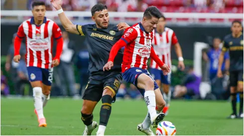 Alexis Vega (L) of Toluca fights for the ball with Pavel Perez (R) of Guadalajara