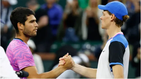 Carlos Alcaraz of Spain shakes hands with Jannik Sinner of Italy