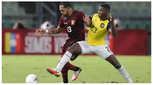 Jose Martinez of Venezuela and Moises Caicedo of Ecuador fight for the ball during a match between Venezuela and Ecuador