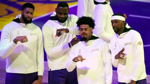 Anthony Davis #3, LeBron James #23, Quinn Cook #2 and Kentavious Caldwell-Pope #1 of the Los Angeles Lakers pose during the 2020 NBA championship ring ceremony before their opening night game against the Los Angeles Clippers at Staples Center on December 22, 2020 in Los Angeles, California.