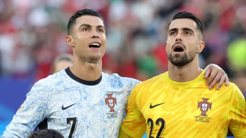 Cristiano Ronaldo of Portugal sings their national anthem with teammate Diogo Costa prior to the UEFA EURO 2024 group stage match between Georgia and Portugal at Arena AufSchalke on June 26, 2024 in Gelsenkirchen, Germany.