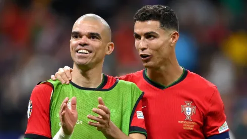 Pepe and Cristiano Ronaldo of Portugal celebrate following the team's victory in the penalty shoot out during the UEFA EURO 2024 round of 16 match between Portugal and Slovenia at Frankfurt Arena on July 01, 2024 in Frankfurt am Main, Germany.