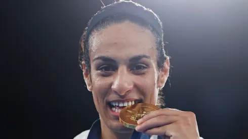 Gold Medallist Imane Khelif of Team Algeria bites her medal during the Boxing Women's 66kg medal ceremony