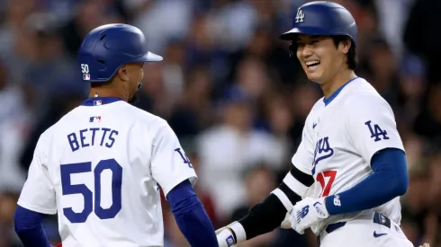 Shohei Ohtani #17 of the Los Angeles Dodgers celebrates his two run home run with Mookie Betts #50, to take a 3-0 lead over the Cincinnati Reds, during the third inning at Dodger Stadium.