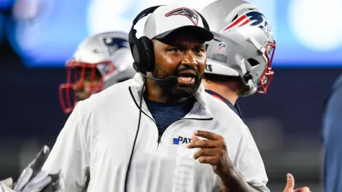Head coach of the Jerod Mayo speaks to his staff during the second quarter of a preseason game against the Carolina Panthers at Gillette Stadium on August 08, 2024 in Foxborough, Massachusetts.