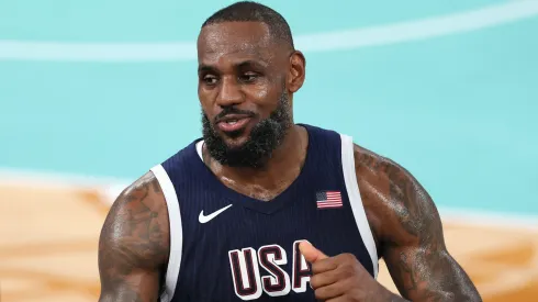 LeBron James #6 of Team United States high fives former NBA player Carmelo Anthony after Team United States's victory against Team France during the Men's Gold Medal game between Team France and Team United States on day fifteen of the Olympic Games Paris 2024.