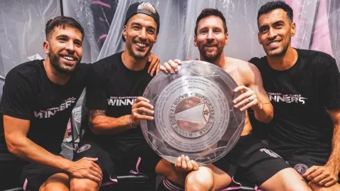 Jordi Alba, Luis Suarez, Lionel Messi, and Sergio Busquets with the Supporters Shield.