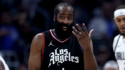 James Harden #1 of the LA Clippers reacts between Daniel Gafford #21 and Kyrie Irving #11 of the Dallas Mavericks during the first half at Crypto.com Arena on April 23, 2024 in Los Angeles, California.