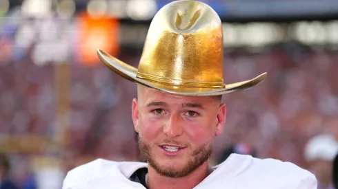 Quinn Ewers #3 of the Texas Longhorns wears the Golden Hat Trophy after defeating the Oklahoma Sooners 34-3 at Cotton Bowl Stadium on October 12, 2024 in Dallas, Texas.