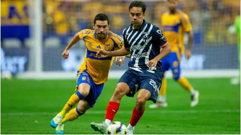 Juan Pablo Vigon (L) of Tigres fights for the ball with Iker Fimbres (R) of Monterrey
