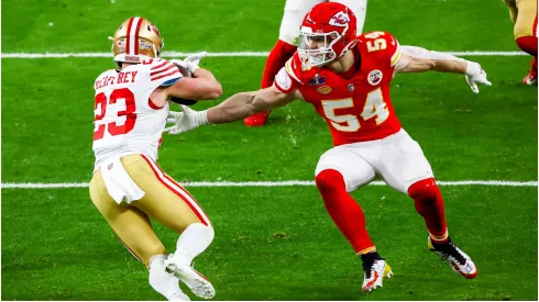 Kansas City Chiefs linebacker Leo Chenal attempts to maneuver toward San Francisco 49ers running back Christian McCaffrey