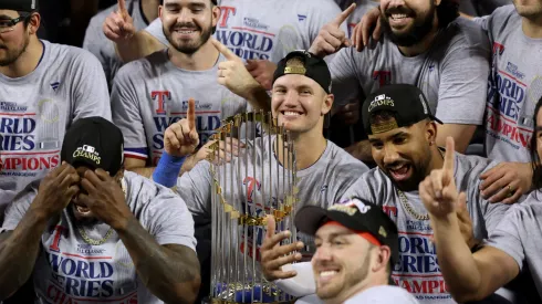 Josh Jung #6 of the Texas Rangers smiles with the trophy after defeating the Arizona Diamondbacks 5-0 in Game Five of the World Series at Chase Field on November 01, 2023 in Phoenix, Arizona.