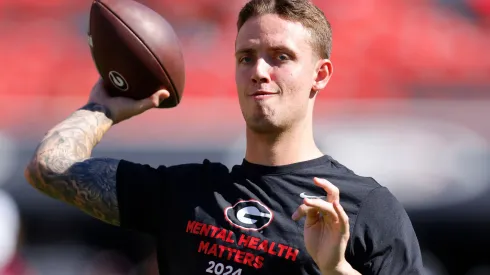 Carson Beck #15 of the Georgia Bulldogs warms up prior to the game against the Mississippi State Bulldogs at Sanford Stadium on October 12, 2024 in Athens, Georgia.