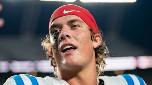 Jaxson Dart #2 of the Mississippi Rebels holds up a phone while walking off the field after defeating the South Carolina Gamecocks during their game at Williams-Brice Stadium on October 05, 2024 in Columbia, South Carolina.