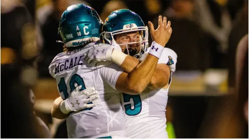 Coastal Carolina Chanticleers quarterback Grayson McCall celebrates with tight end<br />
Kendall Karr