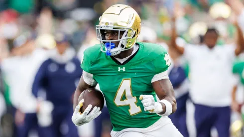 tre Dame running back Jeremiyah Love (4) runs with the ball during NCAA game action between the Louisville Cardinals and the Notre Dame Fighting Irish at Notre Dame Stadium in South Bend, Indiana.