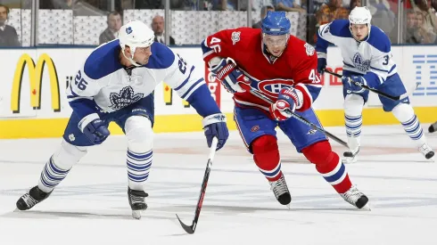 Andrei Kostitsyn #46 of the Montreal Canadiens races for the puck against Mike Van Ryn #26 of the Toronto Maple Leafs during their NHL game on October 11, 2008.