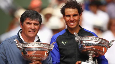 Rafael Nadal of Spain celebrates Roland Garros victory with the trophy alongside coach Toni Nadal.