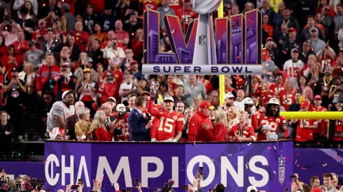 Patrick Mahomes #15 of the Kansas City Chiefs holds the Lombardi Trophy after defeating the San Francisco 49ers 25-22 in overtime during Super Bowl LVIII in 2024.