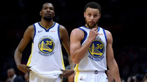 Stephen Curry #30 and Kevin Durant #35 of the Golden State Warriors react as they leave the game late in the fourth quarter againts the Clippers.
