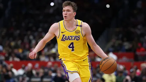 Dalton Knecht #4 of the Los Angeles Lakers controls the ball against the Washington Wizards during the second half at Capital One Arena.
