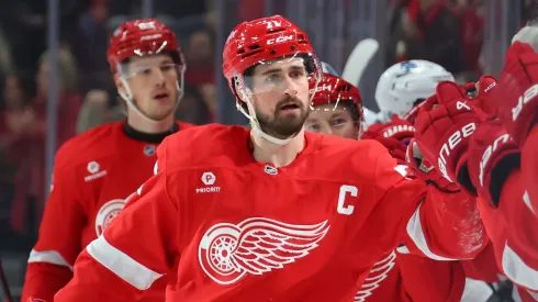 Dylan Larkin #71 of the Detroit Red Wings celebrates his first period goal with teammates while playing the Utah Hockey Club at Little Caesars Arena on March 06, 2025 in Detroit, Michigan.