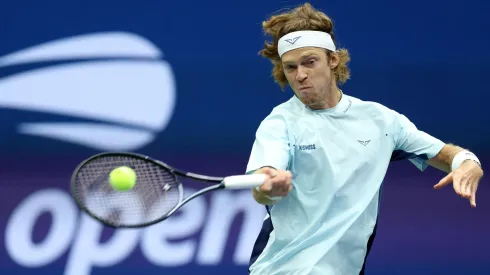 Andrey Rublev of Russia returns a shot against Grigor Dimitrov of Bulgaria during the 2024 US Open.