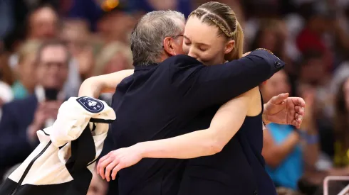 Head coach Geno Auriemma and Paige Bueckers #5 of the UConn Huskies embrace in the fourth quarter against the South Carolina Gamecocks in the National Championship of the NCAA Women's Basketball Tournament at Amalie Arena on April 06, 2025 in Tampa, Florida.