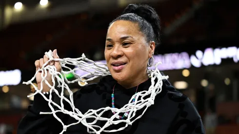 Head coach Dawn Staley of the South Carolina Gamecocks wears the net after their win over the LSU Lady Tigers following the championship game of the SEC Women's Basketball Tournament at Bon Secours Wellness Arena on March 10, 2024 in Greenville, South Carolina.