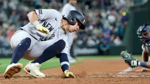 Oswaldo Cabrera #95 of the New York Yankees scores a run against the Seattle Mariners during the ninth inning but injures himself at T-Mobile Park on May 12, 2025 in Seattle, Washington.