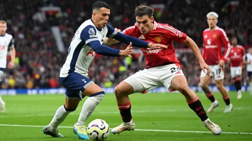Pedro Porro of Tottenham Hotspur is challenged by Manuel Ugarte of Manchester United during the Premier League match between Manchester United FC and Tottenham Hotspur FC at Old Trafford on September 29, 2024 in Manchester, England.