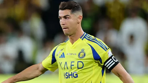 Cristiano Ronaldo of Al Nassr passes the ball whilst under pressure from Houssem Aouar of Al-Ittihad during the Saudi Pro League match between Al Nassr and Al Ittihad at Al-Awwal Park on May 07, 2025 in Riyadh, Saudi Arabia.