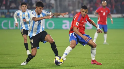 Alexis Sanchez of Chile controls the ball whilst under pressure from Exequiel Palacios of Argentina