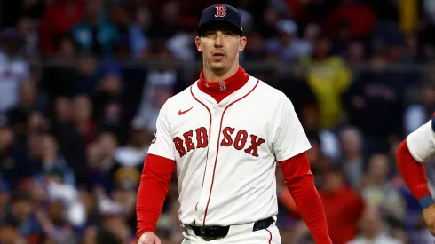 Pitcher Walker Buehler #0 of the Boston Red Sox heads for the clubhouse after being thrown out of the game for arguing balls and strikes as catcher Carlos Narváez #75 looks on, during the second inning against the New York Mets at Fenway Park on May 20, 2025 in Boston, Massachusetts.