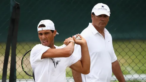 Rafael Nadal of Spain plays a backhand in a training session with coach and uncle Toni Nadal at Wimbledon on July 9, 2017 in London, England.